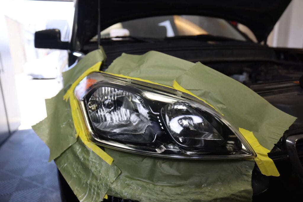 Picture of taped off headlight that has been repaired in our headlight renewal training course.