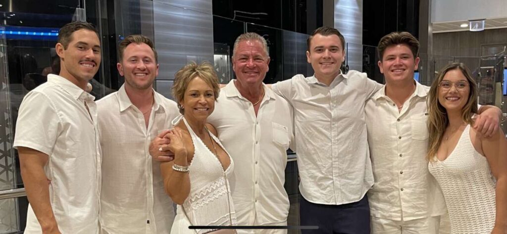 A group of people dressed in white Meet The King, posing for a photo.