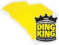 Logo of "The Ding King Paintless Dent Repair Training School" featuring a yellow and white graphic resembling a car dent, with a black crown on top.