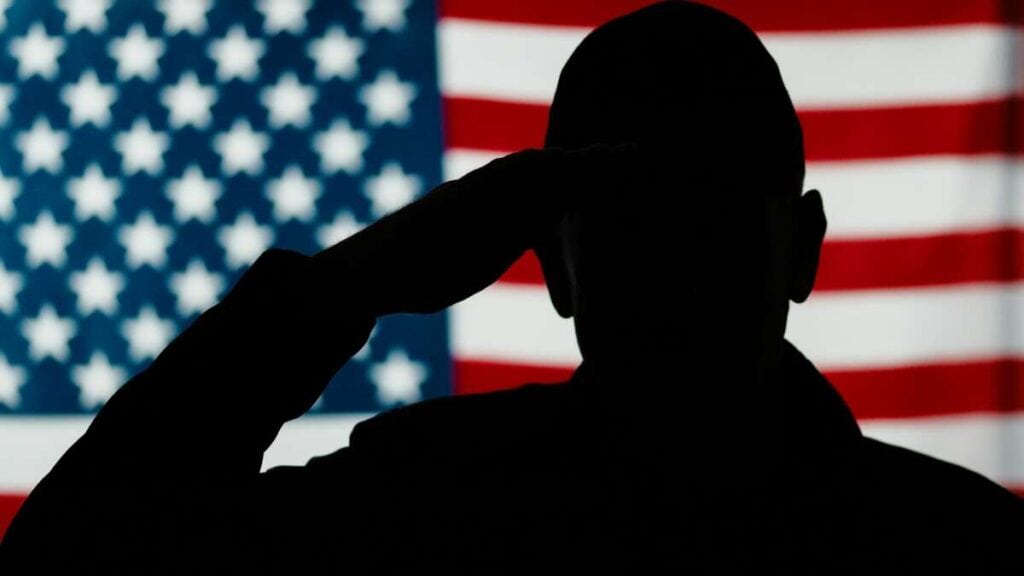 Silhouette of a person saluting in front of an American flag, embodying the spirit of dedication you’ll find in Advanced PDR Training.