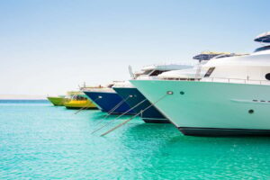 Anchored big yachts and sailboats on a turquoise water